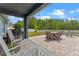 Covered patio features brick pavers, patio furniture, grill, and string lights at 820 Timber Isle Dr, Orlando, FL 32828