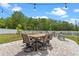 Spacious patio with dining set, string lights, and white picket fence overlooking the yard at 820 Timber Isle Dr, Orlando, FL 32828