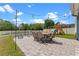 Paver patio with dining set, lounge chairs, fire pit, and playground in fenced backyard at 820 Timber Isle Dr, Orlando, FL 32828