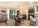 Well-lit dining room features modern light fixture, wood floors, and sliding glass doors to the outside at 85 Carolwood Blvd, Fern Park, FL 32730