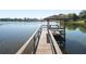 Community dock on calm lake with shelter and bench seating at 85 Carolwood Blvd, Fern Park, FL 32730