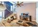 Bright living room with high ceilings, a ceiling fan, and stairs that lead to the upper level at 85 Carolwood Blvd, Fern Park, FL 32730