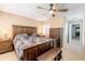 Spacious bedroom with a ceiling fan, plantation shutters, dresser, and carpet at 85 Carolwood Blvd, Fern Park, FL 32730
