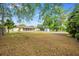 Expansive backyard featuring a large grassy area, mature trees, and a storage shed at 870 Darwin Dr, Altamonte Springs, FL 32701