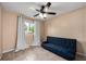 Bedroom with tile floors, a ceiling fan, a futon, and natural light from the window at 870 Darwin Dr, Altamonte Springs, FL 32701