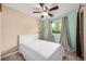 Well-lit bedroom features a neutral color scheme and a large window at 870 Darwin Dr, Altamonte Springs, FL 32701