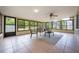 Bright sunroom with tiled floor, many windows providing backyard views, and casual seating area at 870 Darwin Dr, Altamonte Springs, FL 32701