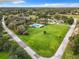 Expansive green lawn with a community pool nestled in a residential neighborhood at 1 Huntley Ct, Haines City, FL 33844