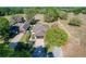 Aerial shot of home displaying well-manicured lawn, mature trees and driveway with golf cart at 1 Huntley Ct, Haines City, FL 33844