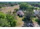 Another aerial view showcasing home's setting with mature trees and green space, highlighting privacy at 1 Huntley Ct, Haines City, FL 33844