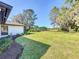 Expansive backyard with lush greenery, mature trees, and a neatly landscaped garden, ideal for outdoor relaxation at 1 Huntley Ct, Haines City, FL 33844