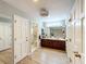 Bathroom boasts wood look floors, double vanity, and multiple doors, creating an open and accessible space at 1 Huntley Ct, Haines City, FL 33844
