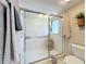 Bathroom features glass shower doors, tiled walls, neutral paint, and convenient grab bar at 1 Huntley Ct, Haines City, FL 33844