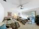Bright bedroom with twin beds, a ceiling fan, carpet, and sliding glass door leading to the outside at 1 Huntley Ct, Haines City, FL 33844