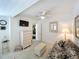Cozy bedroom features a daybed, dresser, ceiling fan, and a mounted television for comfortable, stylish living at 1 Huntley Ct, Haines City, FL 33844