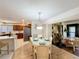 Bright dining area with a sliding glass door, a view to the outside, and seamless access to the kitchen at 1 Huntley Ct, Haines City, FL 33844