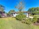 Well-maintained home with lush landscaping, mature trees, and a vibrant green lawn, creating a serene setting at 1 Huntley Ct, Haines City, FL 33844