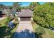 Charming single-story home with a manicured lawn, a two-car garage, and a golf cart parked in the driveway at 1 Huntley Ct, Haines City, FL 33844