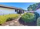 Beautifully landscaped front yard with stone pathway, lush bushes, and mulch, creating a welcoming entrance to the home at 1 Huntley Ct, Haines City, FL 33844