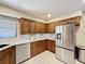 Modern kitchen featuring stainless steel appliances, including a refrigerator and dishwasher, and ample cabinet space at 1 Huntley Ct, Haines City, FL 33844