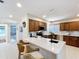 Bright kitchen featuring an island with breakfast bar seating, white countertops, and wooden cabinets at 1 Huntley Ct, Haines City, FL 33844