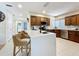 Bright kitchen featuring an island with breakfast bar seating, white countertops, and wooden cabinets at 1 Huntley Ct, Haines City, FL 33844