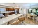 Open-concept kitchen featuring an island with breakfast bar seating, wooden cabinets, and stainless-steel appliances at 1 Huntley Ct, Haines City, FL 33844