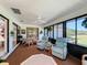 Cozy lanai with seating, a ceiling fan and views of a well maintained lawn at 1 Huntley Ct, Haines City, FL 33844