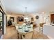 Spacious living room featuring wood floors, tray ceiling, modern furnishings, and a dining area with a chandelier at 1 Huntley Ct, Haines City, FL 33844