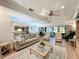 Open-concept living room with multiple seating areas, leading to screened-in porch at 1 Huntley Ct, Haines City, FL 33844