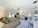 Spacious main bedroom with large windows providing natural light, with carpet flooring and ceiling fan at 1 Huntley Ct, Haines City, FL 33844