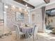 Chic dining area with stone accent wall, and table for four, next to open outdoor space at 10765 Village Lake Rd, Windermere, FL 34786