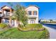 Charming two-story home featuring shutters, manicured lawn and garden with mature tree in a well-maintained community at 10765 Village Lake Rd, Windermere, FL 34786