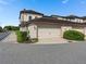 Attached two-car garage with a driveway, manicured hedges, and well-maintained landscaping at 10765 Village Lake Rd, Windermere, FL 34786