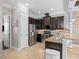 Modern kitchen with stainless steel appliances, dark cabinets, granite countertops and adjacent dining area at 10765 Village Lake Rd, Windermere, FL 34786