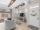 Elegant living room featuring stylish decor, beamed ceiling and seamless access to an outdoor patio at 10765 Village Lake Rd, Windermere, FL 34786