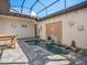 Relaxing screened-in pool area featuring elegant water features and ample patio space at 10765 Village Lake Rd, Windermere, FL 34786