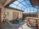 Enclosed pool area with decorative water feature and a table and chairs for outdoor enjoyment at 10765 Village Lake Rd, Windermere, FL 34786