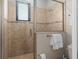 Tiled shower stall with glass door and window for natural light at 10765 Village Lake Rd, Windermere, FL 34786