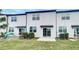 Townhome backyard with a small patio, green grass, and minimal shrubbery at 1112 Merrill St, Davenport, FL 33837