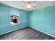 Bedroom with vibrant walls, ceiling fan, and window overlooking the neighborhood at 1112 Merrill St, Davenport, FL 33837