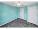 Bedroom featuring bright turquoise walls, ceiling fan, and ample closet space at 1112 Merrill St, Davenport, FL 33837