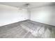 Bright bedroom with neutral walls, carpet, ceiling fan, and multiple doors at 1112 Merrill St, Davenport, FL 33837
