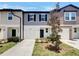 Charming two-story townhome featuring a one car garage and professionally landscaped yard at 1112 Merrill St, Davenport, FL 33837