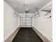Clean garage with overhead storage racks and rubber flooring at 1112 Merrill St, Davenport, FL 33837