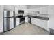 Modern kitchen featuring stainless steel appliances, granite countertops, and white cabinets at 1112 Merrill St, Davenport, FL 33837