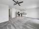 Open-concept living room and kitchen featuring stainless steel appliances and gray carpet at 1112 Merrill St, Davenport, FL 33837