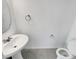 Powder room featuring a pedestal sink, white walls, and modern fixtures at 1112 Merrill St, Davenport, FL 33837
