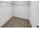 Compact walk-in closet featuring carpeted floors and a wire shelving unit above at 1112 Merrill St, Davenport, FL 33837