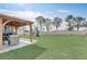 Spacious backyard with a covered patio and room for outdoor activities, including a playset at 11279 Amber Ridge Dr, Zellwood, FL 32798